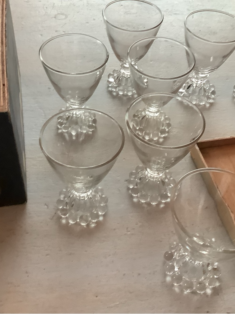 Eight Bewick boogie liqueur or dessert glasses in a country- ish storage box..